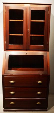 High cabinet in mahogany/brass fittings from M/S Hohenfels, Hansa-Bremen. Double door with bevelled glass and 2 shelves, 1 openable compartment with bevelled glass, 3 drawers.