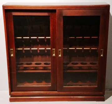 Cabinet with sliding glass doors to store wine and drinking glasses. From the Italian liner M/N G. Verdi. Mahogany/brass, incl 6 storage rails. 