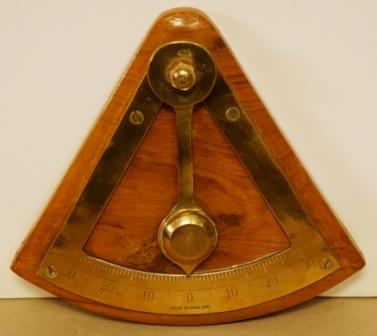 Mid 20th century brass inclinometer mounted on oak base. Made in England. 