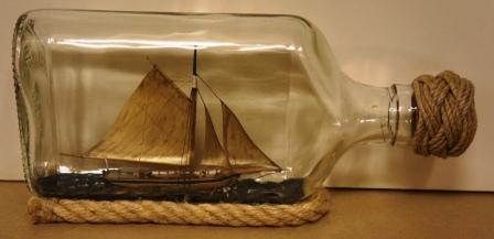 20th century ship model housed in bottle depicting "Klyvarskutan KAROLINA", a traditional Swedish archipelago sloop. Signed GF (Göran Fors).