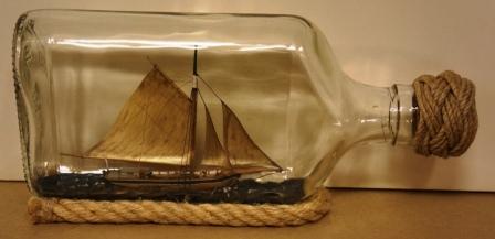 20th century ship model housed in bottle depicting "Klyvarskutan KAROLINA", a traditional Swedish archipelago sloop. Signed GF (Göran Fors). 