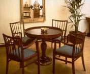 Part of a shipping company guest lounge furnished with restored 20th century original ship's table, armchairs, original binnacle and various navigational instruments.