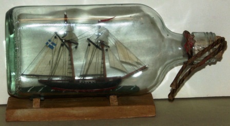 Early 20th century sailor-made ship model housed in bottle. Depicting a Swedish brig. 