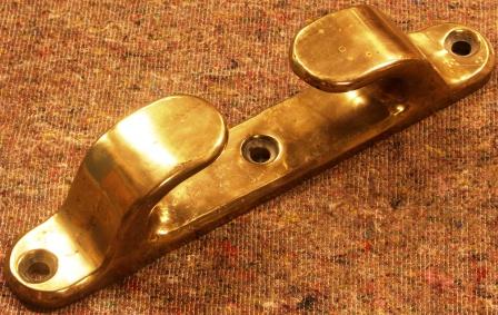 A pair of 20th century cleats in solid brass