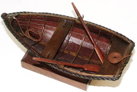 20th century clinker-built wooden dinghy, mounted on wooden base