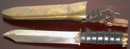 20th century diving knife made in Poland. Brass sheath and rubber-dressed handle. Leather and brass buckle.