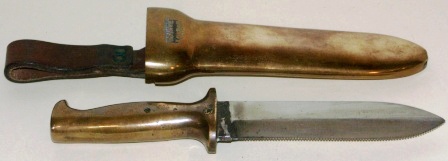 20th century diving knife made by C.E. Heinke & Co. Ltd, London. In brass with double edged blade.