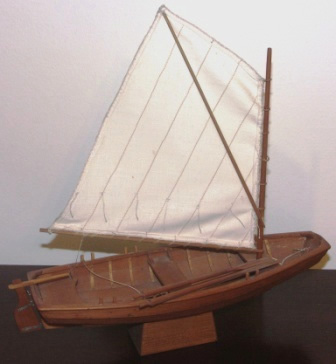 Mid 20th century clinker-built wooden skiff with spritsail