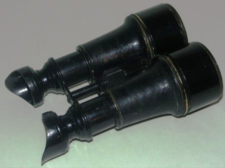 Late 19th century crown-marked binocular made by H. Hughes & Son, London. Marked S.S. & B-Ö. Black lacquered metal and leather. 