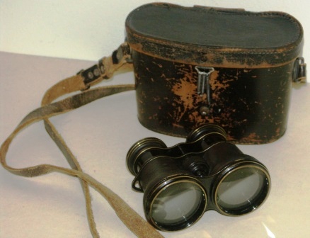 Early 20th century anonymous binocular in black-lacquered brass, leather-bound. In original leather case.