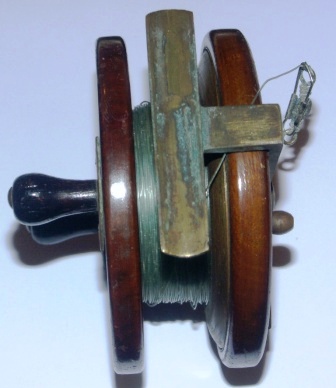 Early 20th century mahogany fishing rod reel with brass fittings.