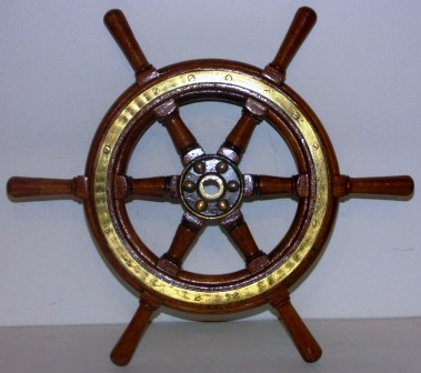 1920's/1930's six-spoked ships wheel. Teak, brass band and hub.