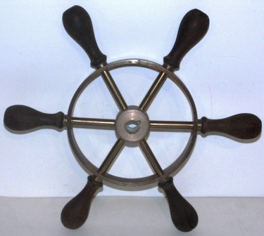 20th century six-spoked brass steering wheel with teak handles. 