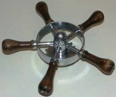 Mid 20th century five-spoked chrome-plated steering wheel with teak handles. 