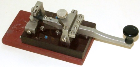 20th century telegraph / morse key, made of metal and mounted on bakelite / metal base
