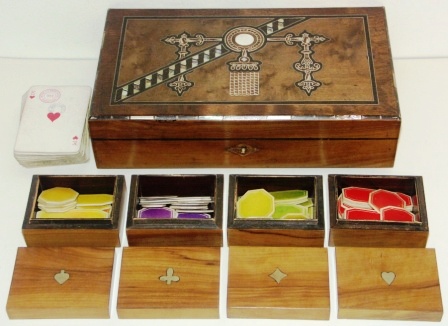 Early 20th century with nacre inlays decorated wooden box containing playing cards and four different types of checkers.