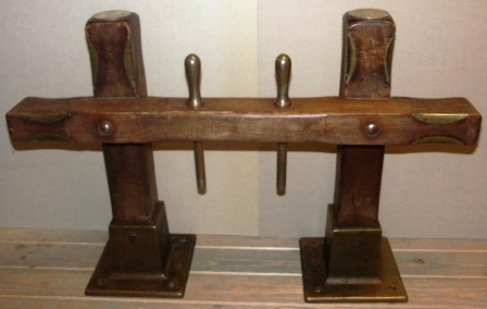 Late 19th century teak belaying pin rack with brass fittings and bronze base. Incl two brass belaying pins. 