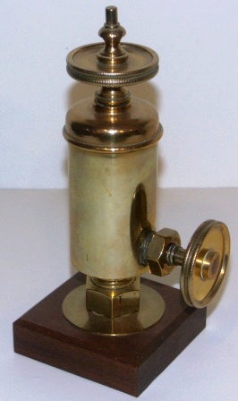 Late 19th century brass steam engine lubricator, mounted on wooden base. 