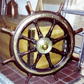 Late 19th century eight-spoked mahogany ships wheel with double brass bands and central brass hub