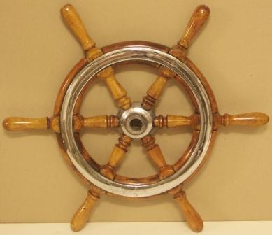 1920's six-spoked ships wheel. Teak, chrome-plated brass band.