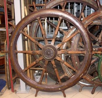 Salvaged mid 19th century ten-spoked ships wheel in teak. Wood and iron hub (incl part of the shaft). With double brass bands. 