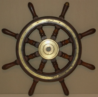 1920's eight-spoked ships wheel. Teak, brass band