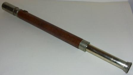 Early 20th century hand-held refracting telescope, maker unknown. One draw, white metal and leather bound tube. 