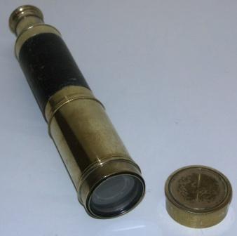Late 19th century hand-held refracting telescope. Maker unknown. Three brass draws, leather bound tube.