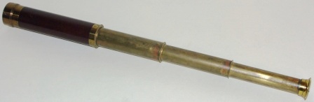 Early 20th century hand-held refracting telescope, maker unknown. With three brass draws and mahogany bound tube.