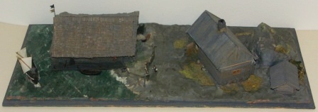 20th century built model depicting a fisherman's home and boathouse (with detachable roofs) on the island Nämndö of Stockholms archipelago. Built 1965-67. Signed H. Biärsjö. Mounted in glass case.