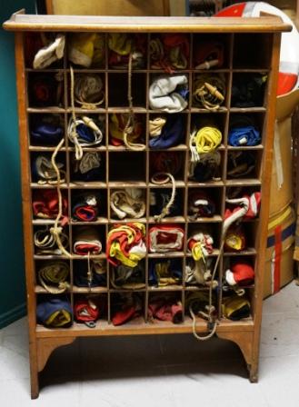 Flag cabinet in teak incl existing flags (incomplete). Untouched/unrestored condition. 