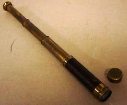 Early 20th century hand-held refracting telescope, maker unknown. Three brass draws and leather bound tube