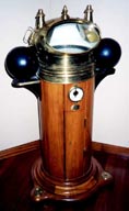 19th century ship's binnacle with dry compass and kerosene lamps.