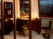 Part of an office interior furnished with restored 20th century original ship's desk, bookcase, swivel-chairs and newly made brass lamp.