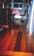 Part of a domestic kitchen, furnished with restored 20th century ship's table, swivel chairs and original deck-planking.