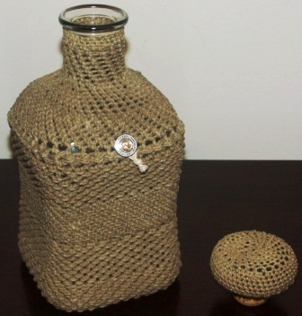 Rope-coated glass bottle with decorative pattern