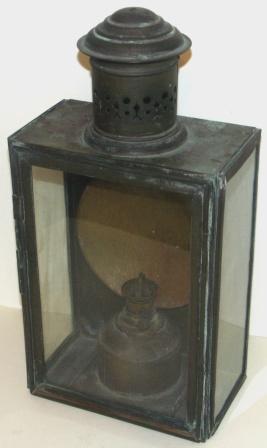 Late 19th century kerosene bulkhead lamp in brass. With detachable burner/container. 