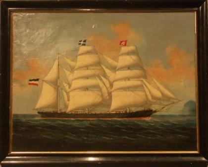 A three-masted barque in full sail flying the German and Hamburg flag